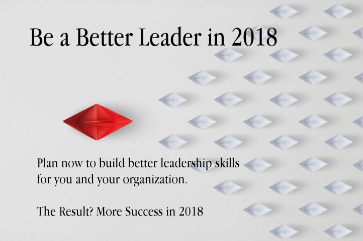 Leadership concept with red paper ship leading among paper ship white.